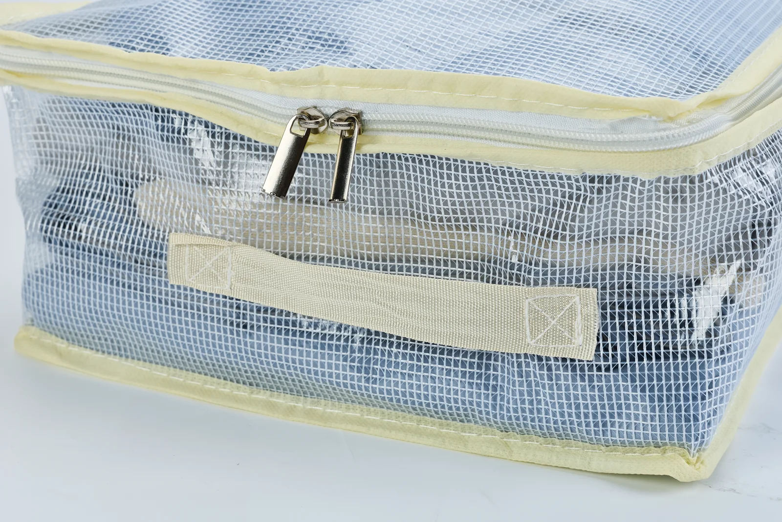 Real product close-up of the handle, zipper and reinforced stitching